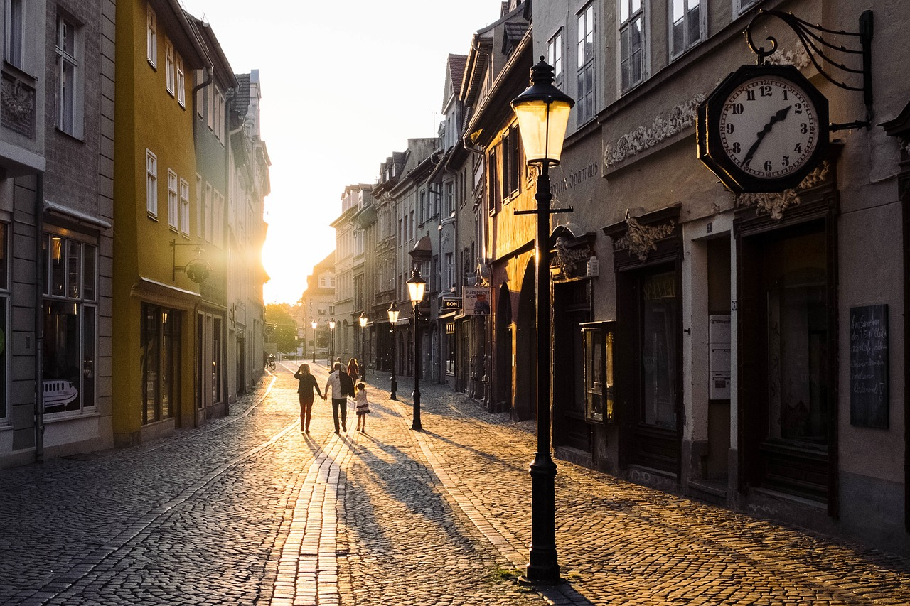 A family walking along a cobblestone street