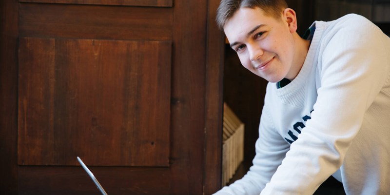 student looking sideways from laptop